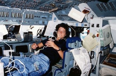 Sally Ride communicates with ground controllers from the flight deck during the six-day mission in Challenger in 1983. The R/V Sally Ride is the U.S.'s first academic research vessel named after a woman. Photo: NASA.